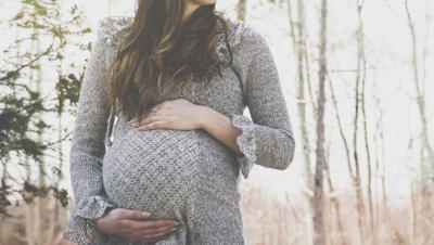 pregnant woman holding stomach